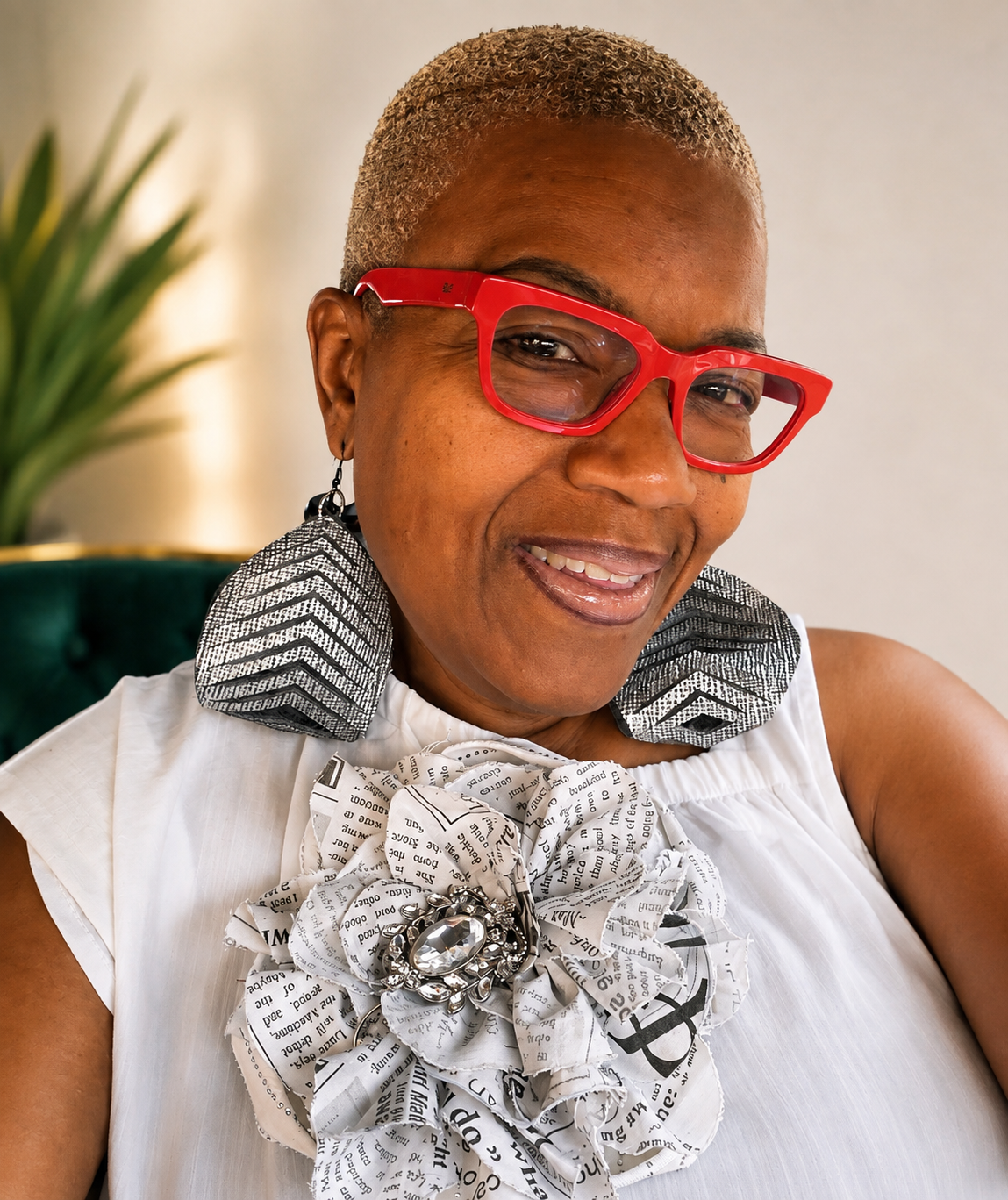 Conya wearing handcrafted statement earrings and a fabric flower brooch
